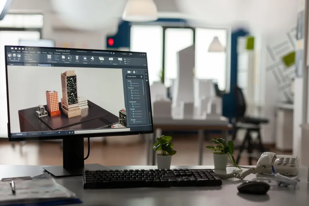 Tela de computador exibindo projeto 3D de edifícios em software de arquitetura