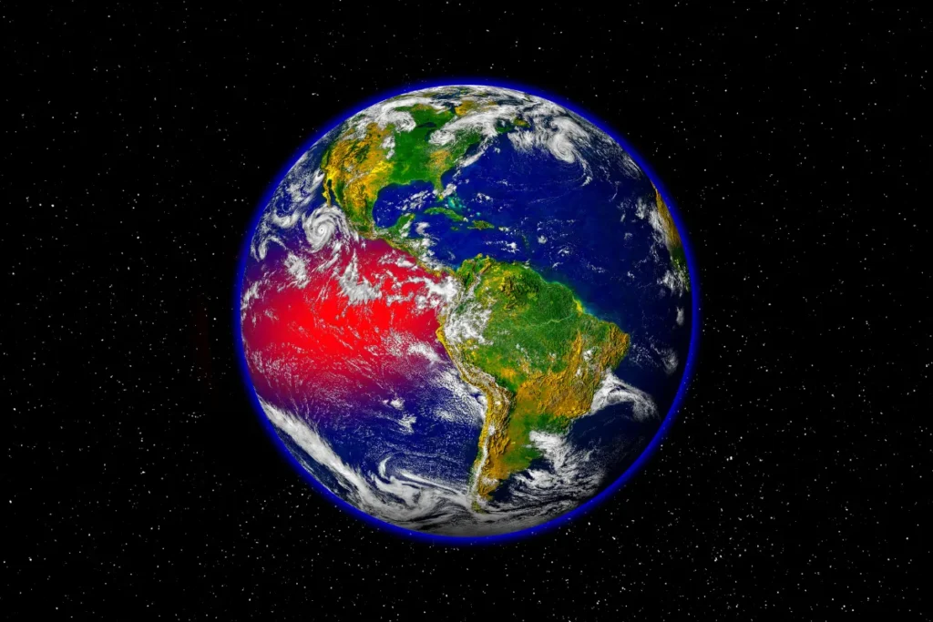 planeta Terra visto do espaço com área em vermelho sobre o oceano indicando aquecimento na região